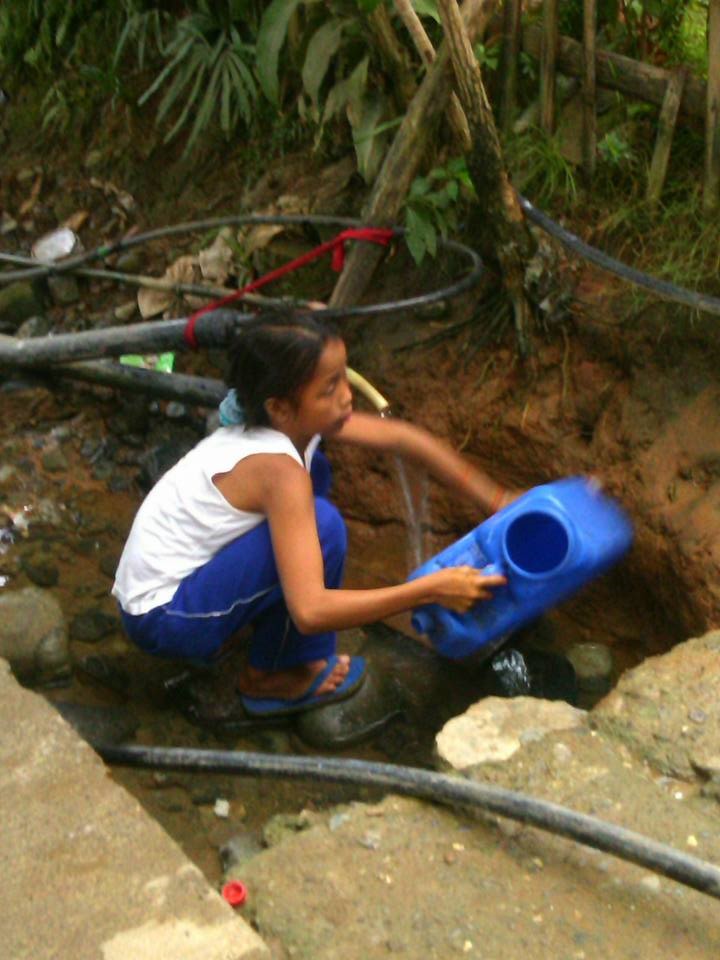 A young girl fetching water in one of the Community’s water station, Photo taken last April 13, 2015